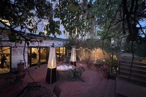 Outdoor Brick Patio with seating, large heaters and string lights.
