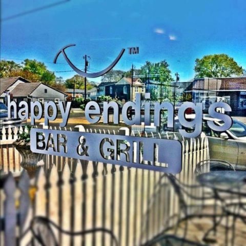 Outside window of Happy Endings Bar & Grill with their logo