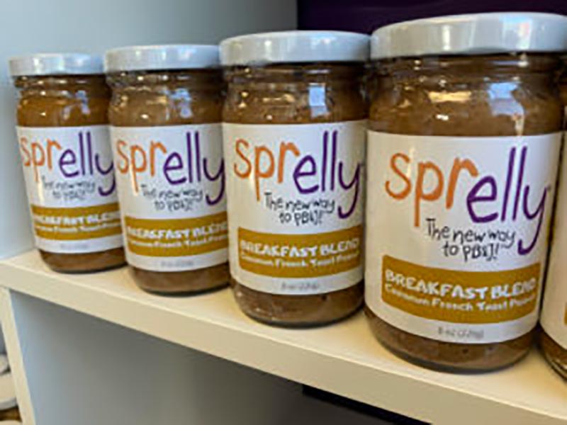 Jars of Sprelly Breakfast Blend peanut butter on a shelf