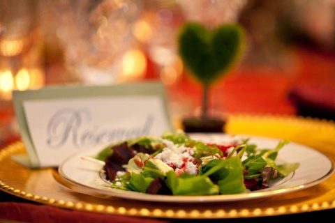 A Taste of Elegance table setting with plated salad on gold charger