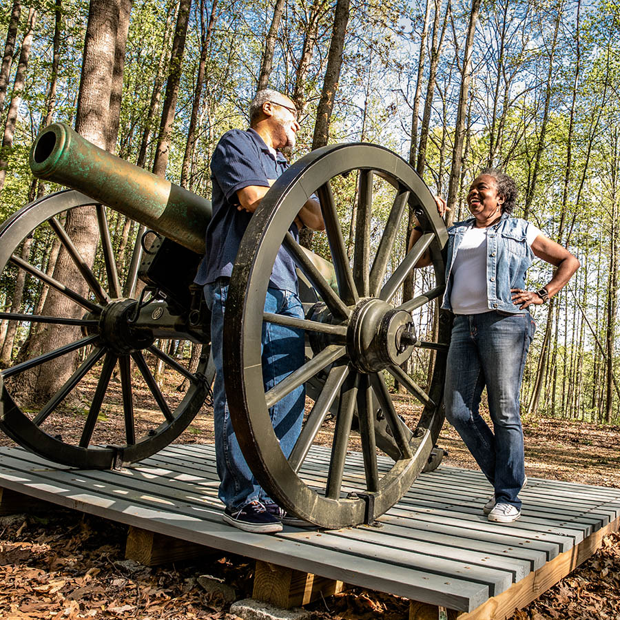 Couple standing near Civil War canon