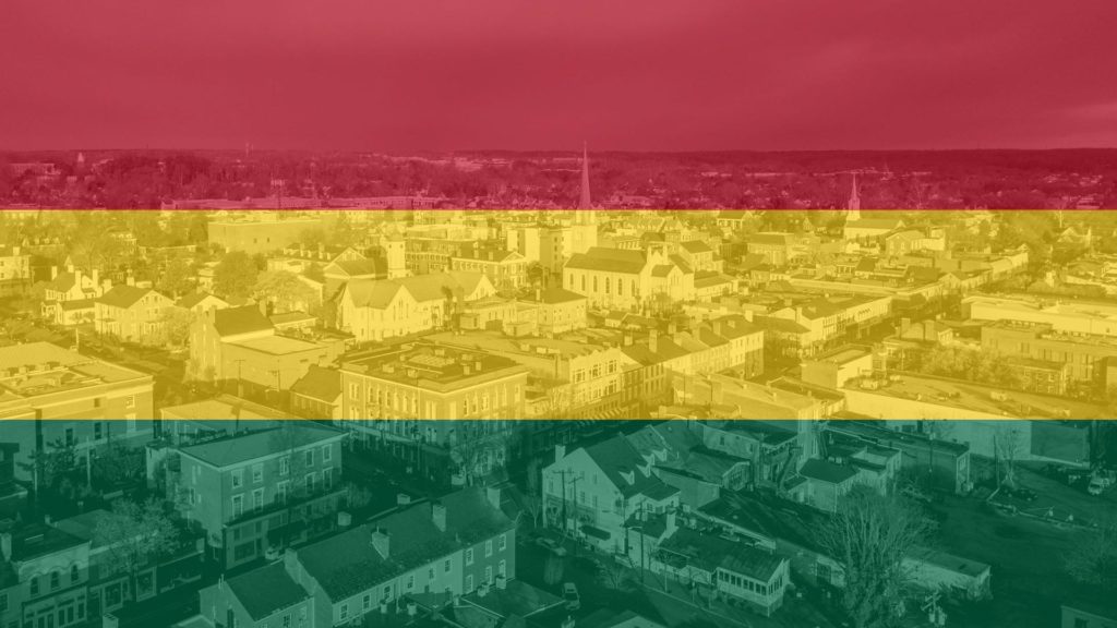 Black History Month flag overtop of aerial view of Fredericksburg