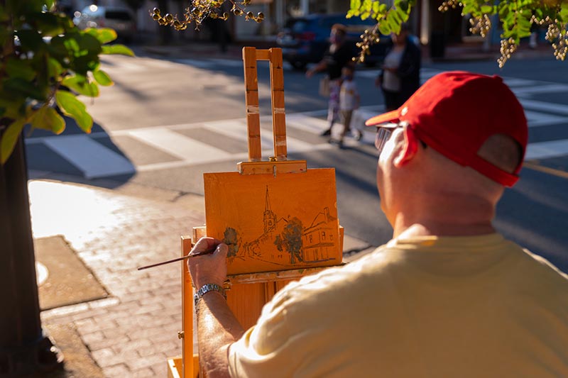Artist painting on the sidewalk