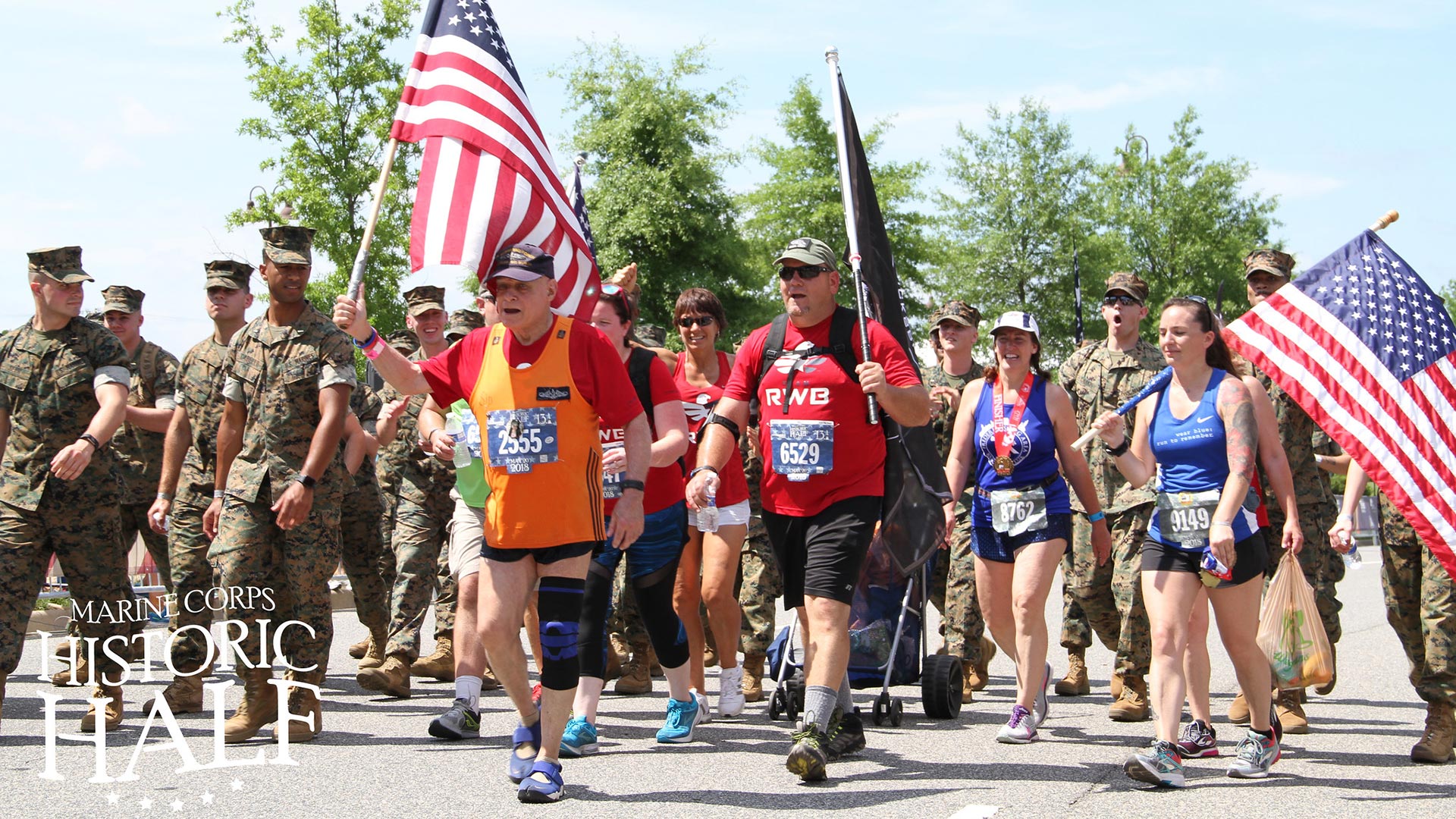 Marines running with participants of Marine Corps Historic Half Marathon