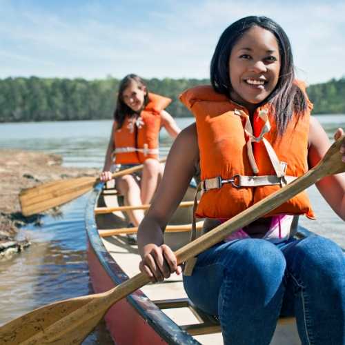 2 ladies in canoe on lake