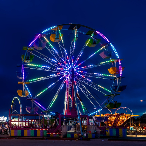 ferris wheel lit up at night at the fair