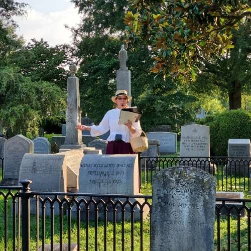 tour guide standing amongst the graves in Fredericksburg City Cemetery
