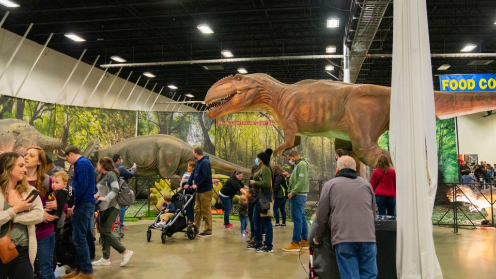 dinosaur looking over people at the fredericksburg expo center
