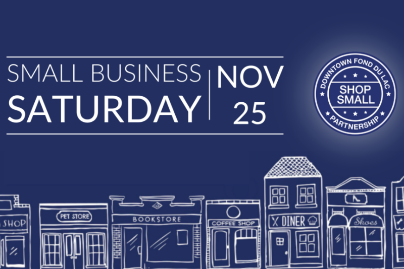 Small Business Saturday November 25 in white on the dark blue sky with small shop buildings at the bottom in white