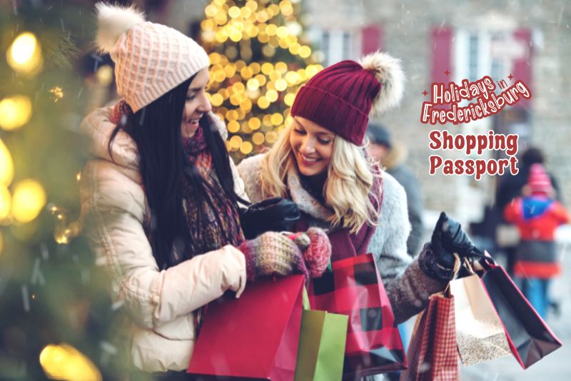 2 ladies smiling and looking at all the shopping bags they are carrying. Ladies are wearing winter coats and hats with puffy beanies. Text on the right Holidays in Fredericksburg Shopping Passport