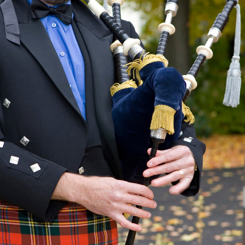 man playing the bag pipes