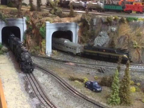 Model Train Set. Train is coming out of a tunnerl