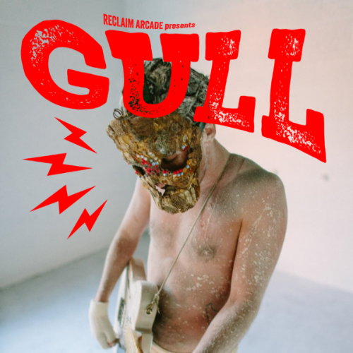Reclaim Arcade presents Gull. Shirtless man is holding a guitar and wearing a brown mask. Man is covered in dirt and glitter.