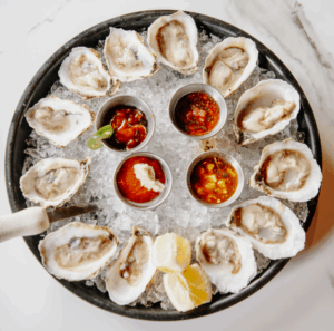 Round plate of oysters from above.