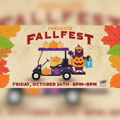 FredNats Mascot, Gus, on the back of a golf cart full of pumpkins.