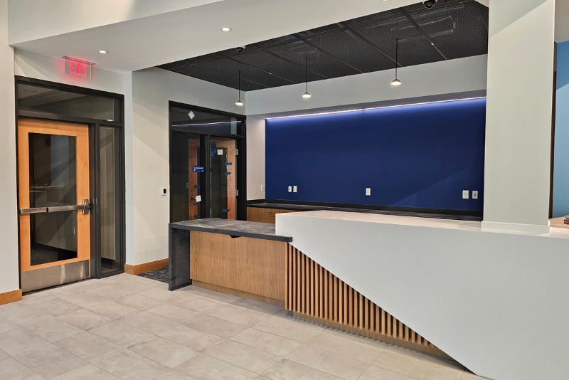 Front counter at the new Fredericksburg Visitor Center. Counter is taller on the right. White beam on the right and back wall of counter is blue.