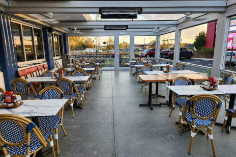 White tables with blue chairs in a restaurant