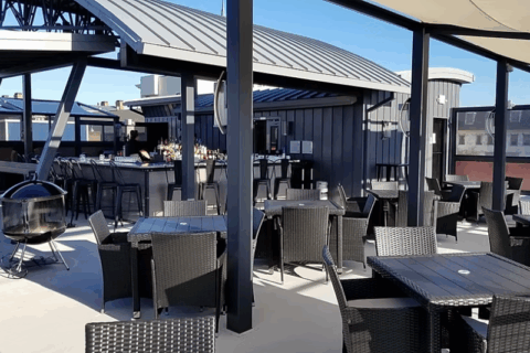 tables and a covered bar on a rooftop.