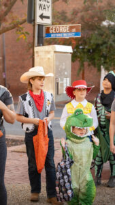 Two young boys dressed up in halloween costumes.