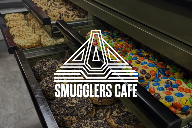 Smugglers Cafe logo over a photo of their cookies.