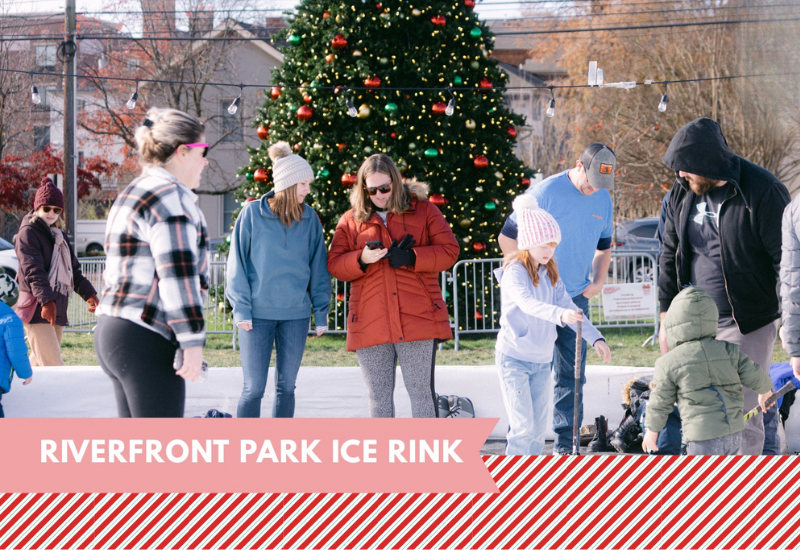 people standing on the ice skating rink with a Christmas tree in the background
