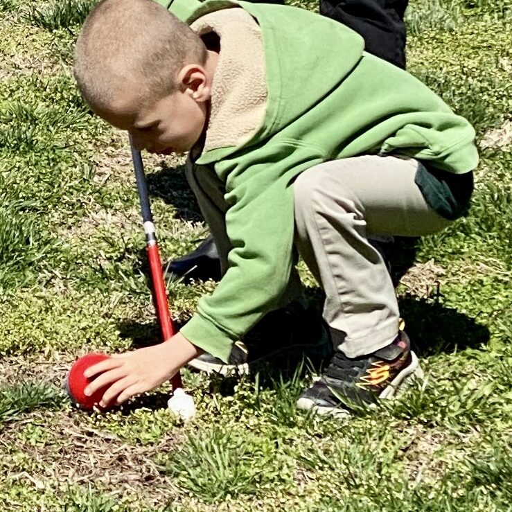 Blind child hunting for easter eggs.