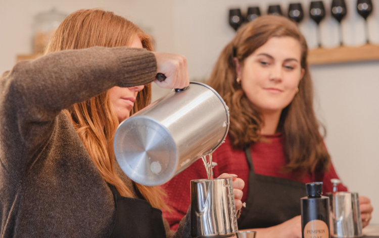 Two women in a candle pouring class