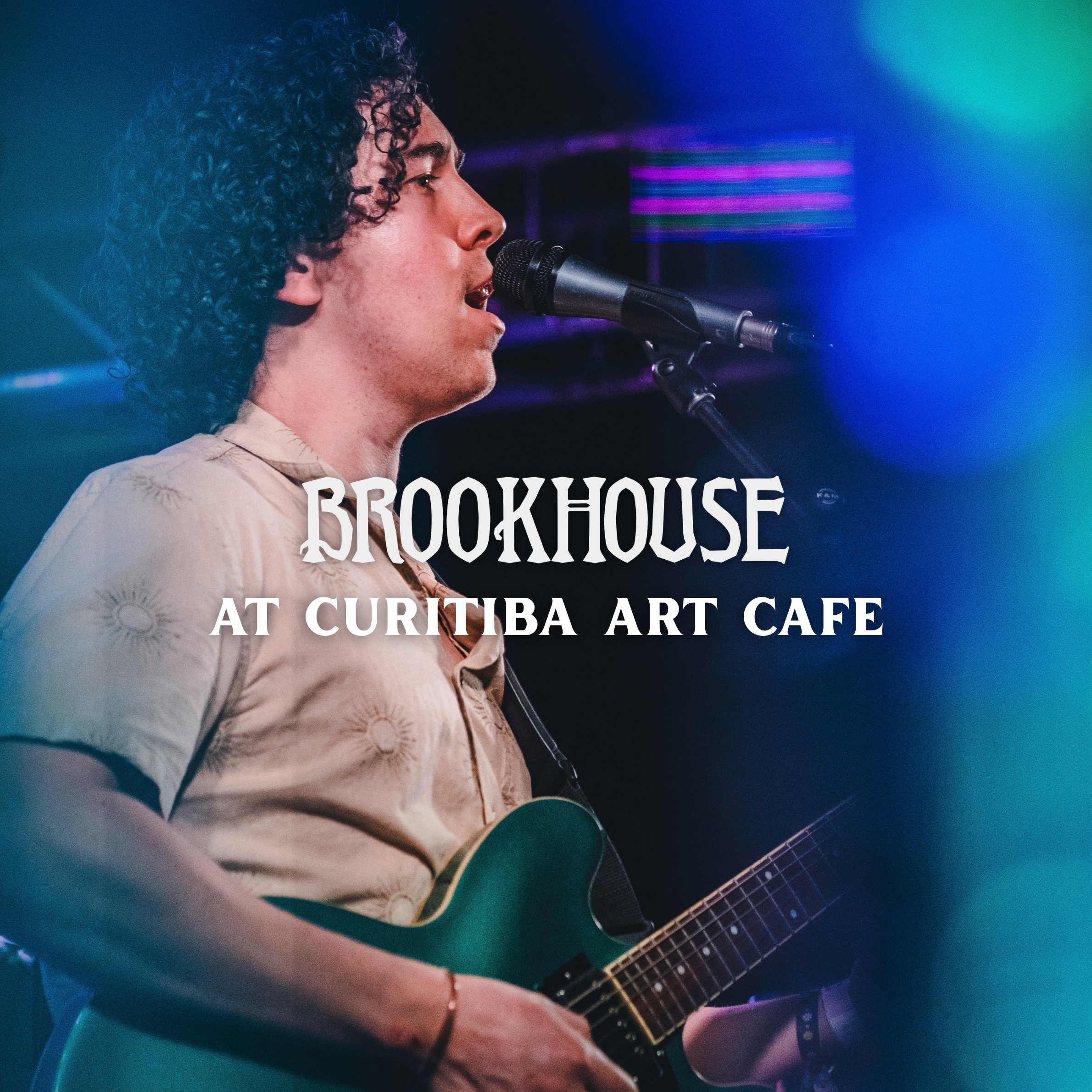 Brookhouse singing into a microphone and playing a guitar. White text that says "Brookhouse at Curitiba Art Cafe".