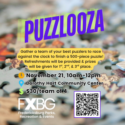 Scattered jigsaw puzzle pieces on a table, with a few light-blue pieces in the foreground and many colorful pieces blurred in the background.