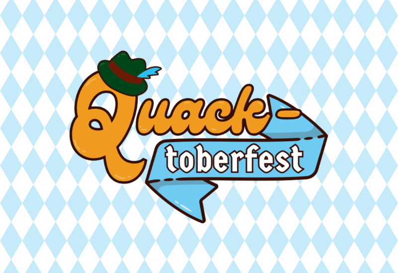 Cartoon orange character wearing a green hat beside blue ribbon text reading “Quack toberfest” on a light blue banner with arrow ends. Blue and white diamond in the background.